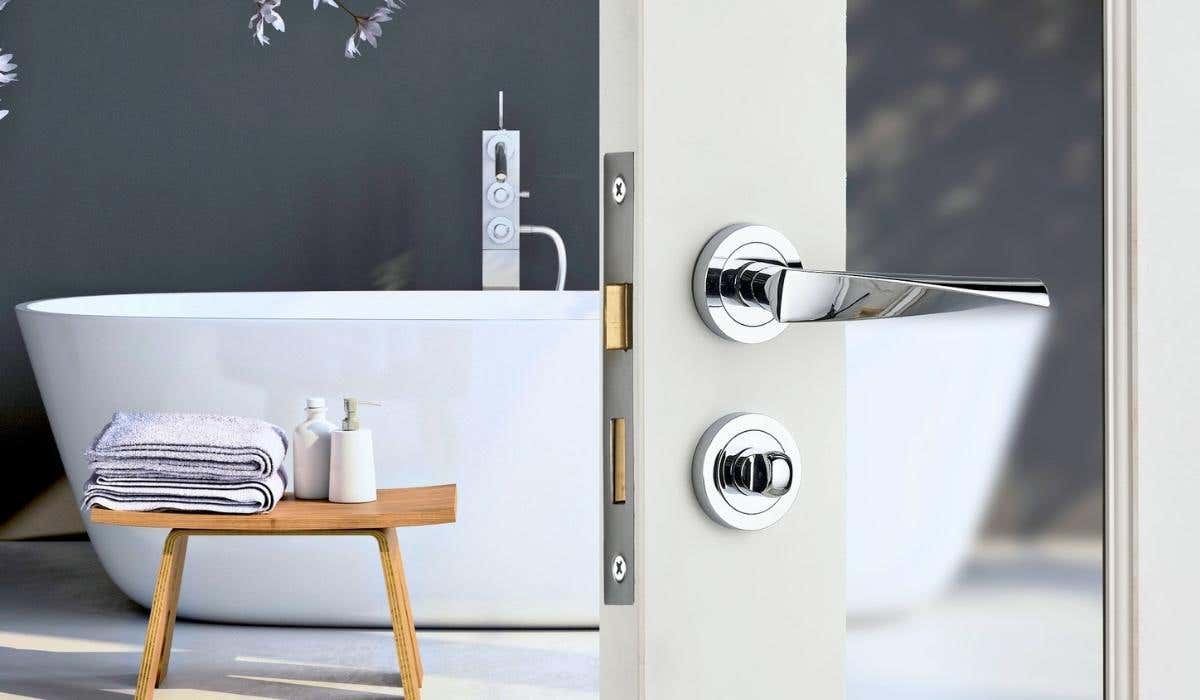 Lever on rose door handle with a thumbturn on a bathroom door