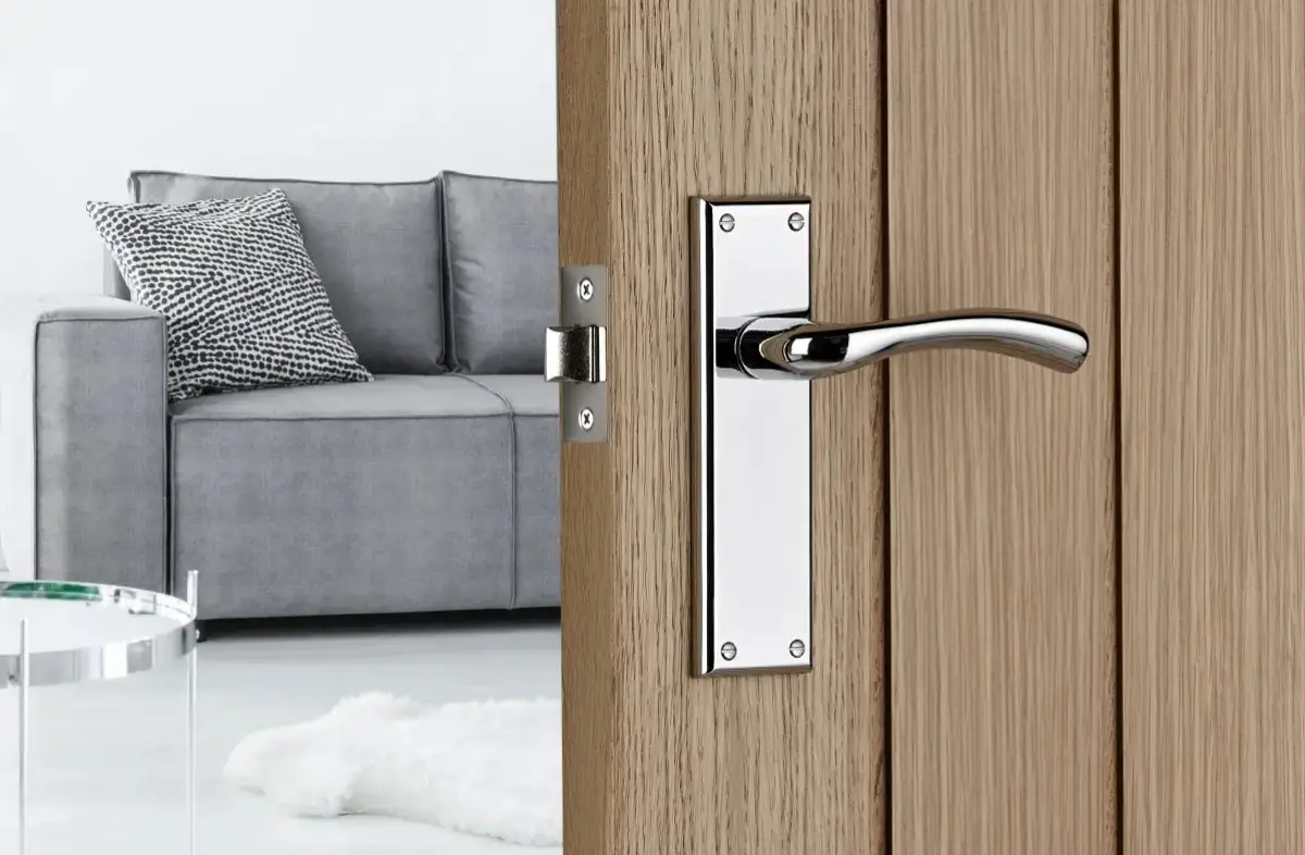 Minerva Door Handle On Backplate in chrome on a wooden door of a bedroom