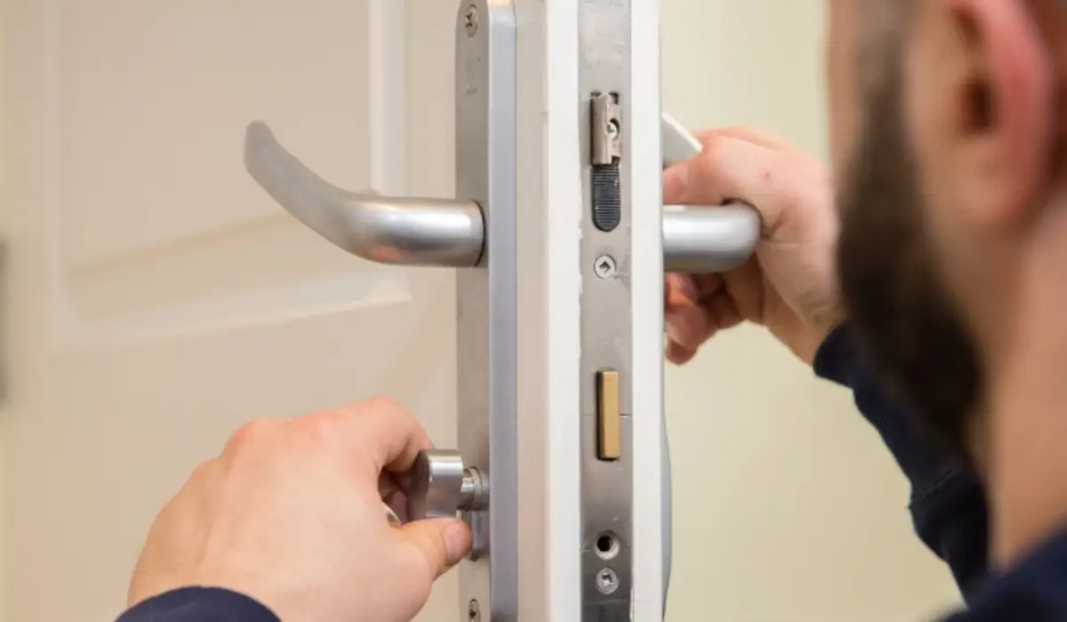 a man fitting a bathroom lock with thumb turn