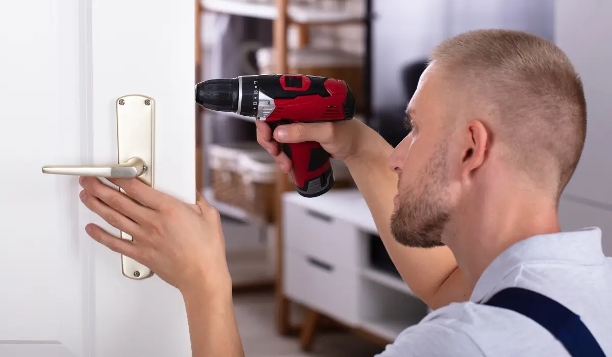 a man unscrewing using a drill